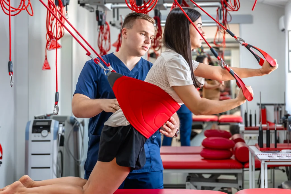 Rehabilitation specialist guiding a patient after spinal fusion surgery.