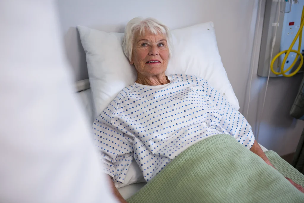 Senior patient resting comfortably in bed after spinal fusion surgery.