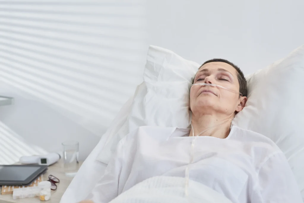 Woman lying in bed during recovery from spinal fusion surgery.