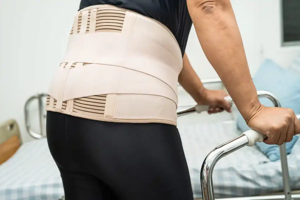 Close-up of a back support belt worn by a patient recovering from spinal fusion failure symptoms.