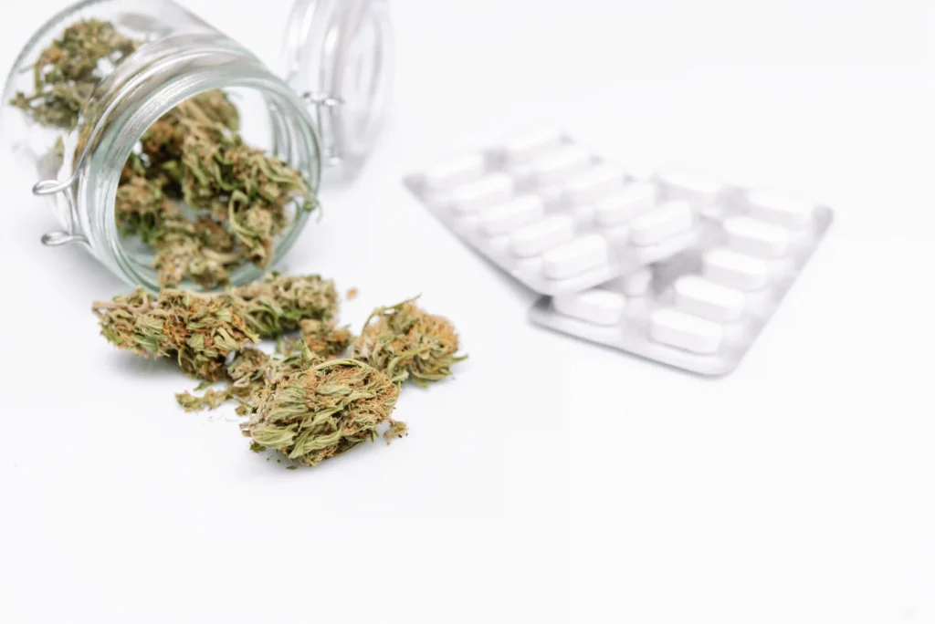 Dried medical marijuana buds in a glass jar for pain management