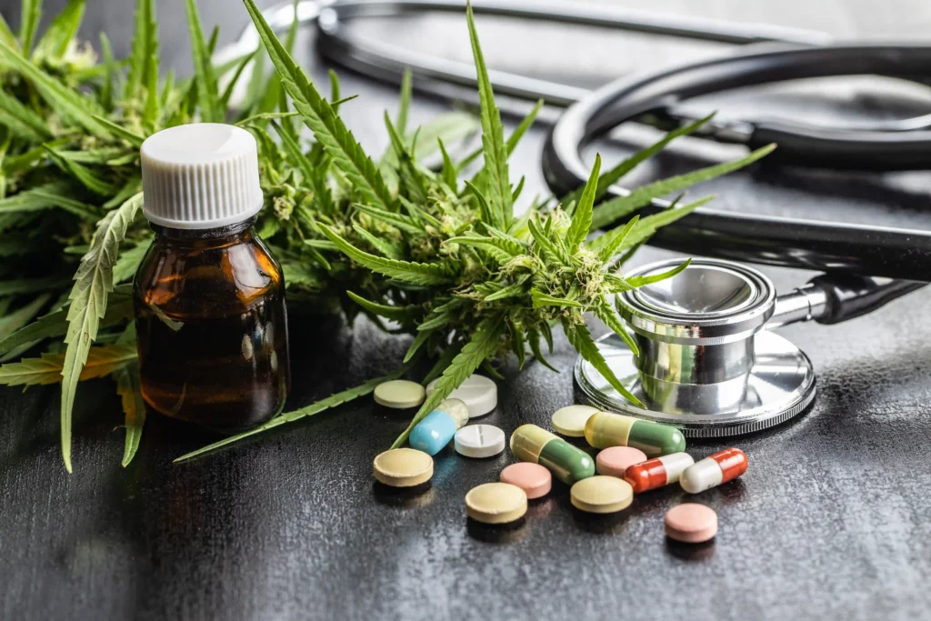 Medical marijuana buds with stethoscope and pills for pain management