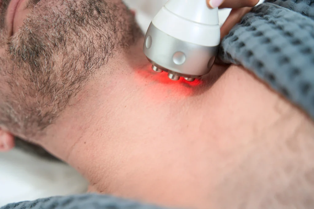 Close-up of a man undergoing advanced neck pain laser treatment to address chronic discomfort.