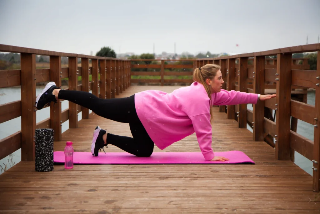 Woman doing outdoor McKenzie Method neck pain exercise to strengthen posture and reduce discomfort.